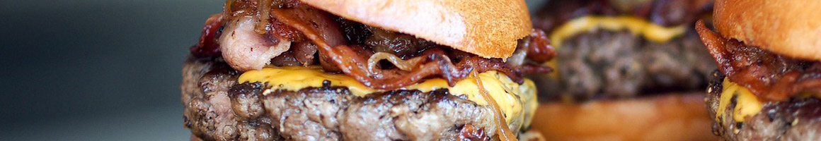 Eating Burger at Burger Madness restaurant in Monroe, WA.